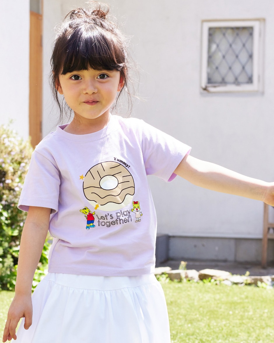 しまじろう　遊べるTシャツ（パープル）を着用して正面を向いて立っている女の子の写真